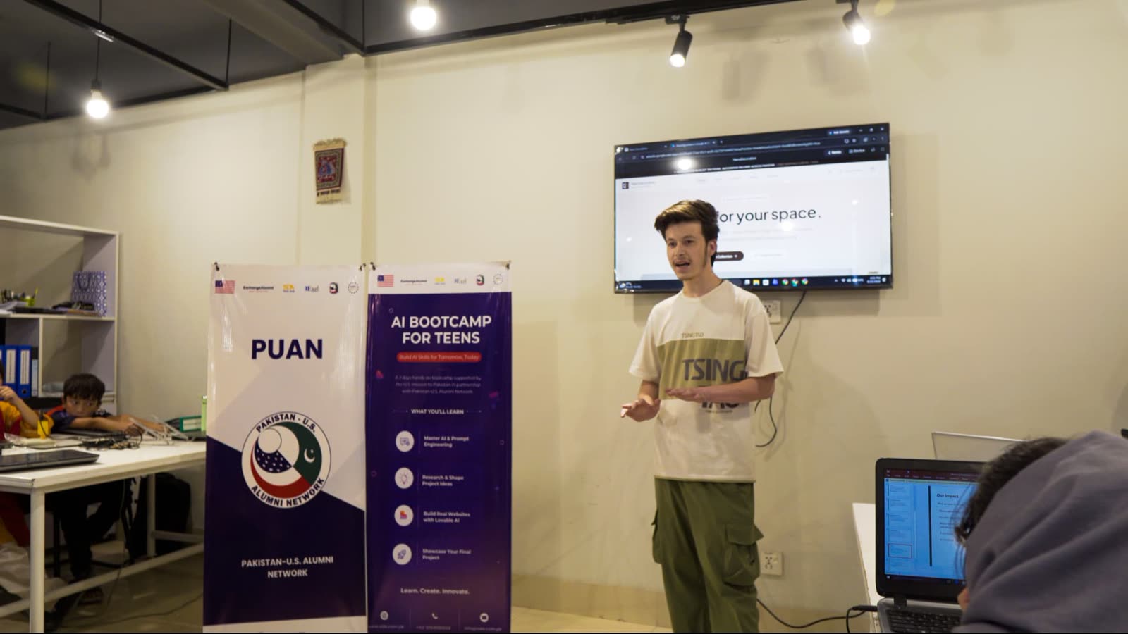A Cohort 2 participant demonstrating a finished web project on screen