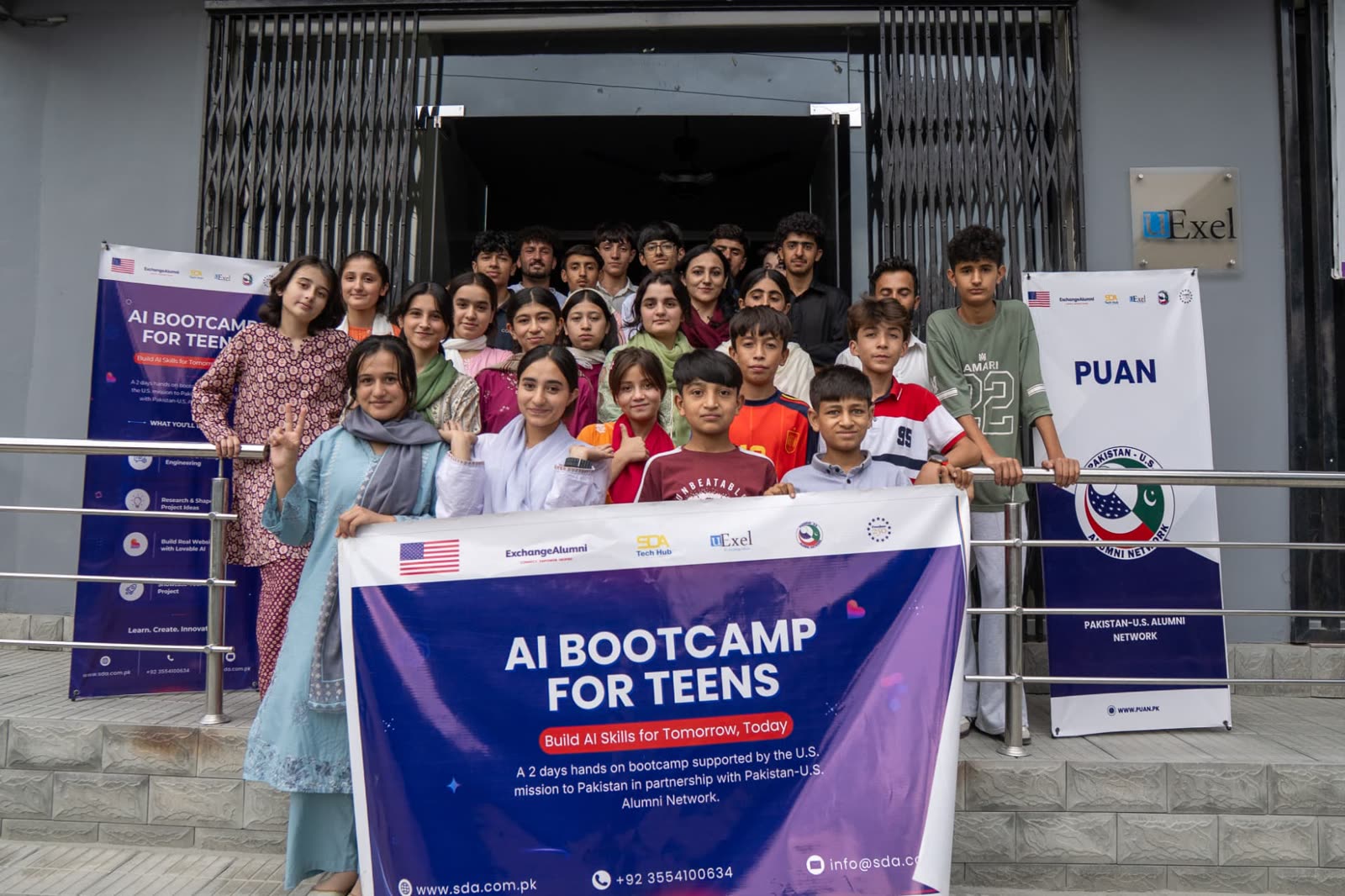 Cohort 2 participants and mentors gathered at the bootcamp venue entrance